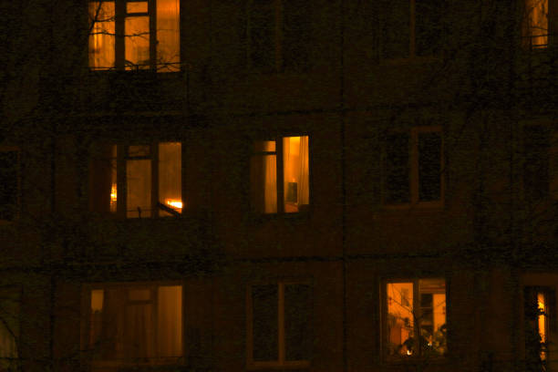 istock apartment building windows lit in the dark 1310493276