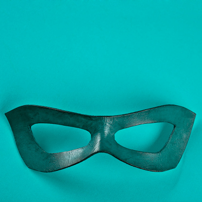 Blue superhero mask on a blue background.