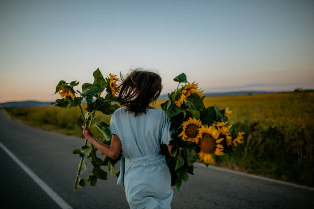 istock Female walking towards sunset 1310494550