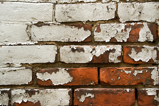 Brick Wall with Peeling White Paint