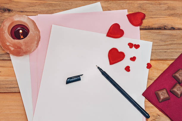 Whit love, love letter, candle, red hearts, pen on colorful paper and chocolate candy Whit love, love letter, candle, red hearts, pen on colorful paper and chocolate candy.  Horizontal photo book heart shape valentines day copy space stock pictures, royalty-free photos & images