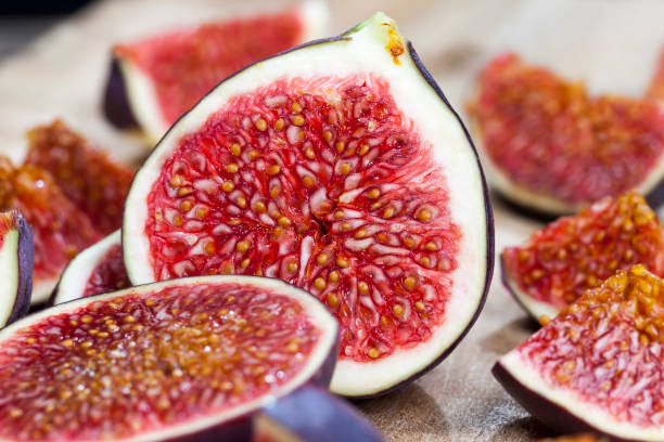 istock sliced fruit of ripe figs on a wooden kitchen board 1310496712
