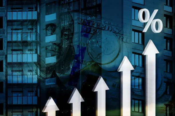 Photo of 3d arrows and percent sign on a background of a building under construction and US banknotes. Concept of growth of financial and mortgage rates, profits in construction industry.