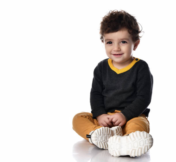 An 11 month old baby boy smiling and showing his baby teeth.
