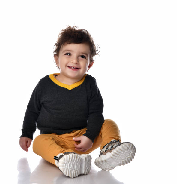 istock Adorable one year old child clapping and having fun, isolated on white 1310498044