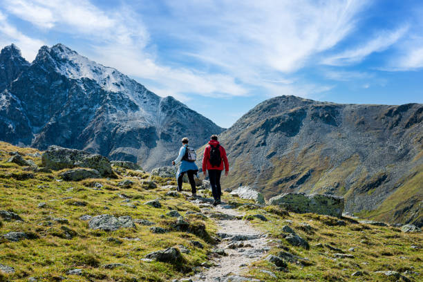 Two hikers on the Muragl valley in the area St.Moritz. stock photo