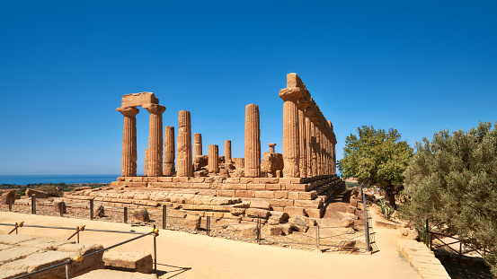 Temple of Juno, Temple of Hera Lacinia, Valley of the Temples, Agrigento, Sicily, Italy. Panoramic banner image taken on bright day, blue sky.