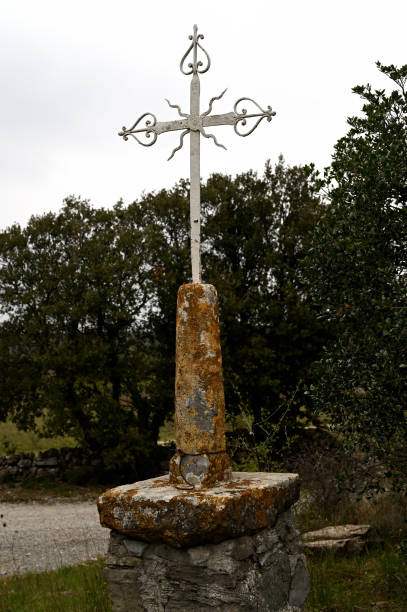 istock Wrought iron christian cross on a white sky 1310501885