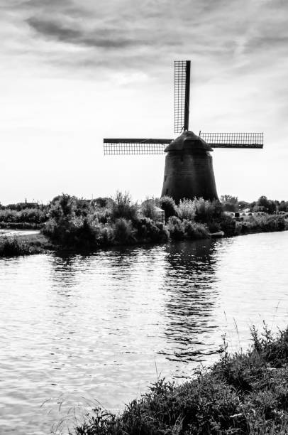 Alkmaar, The Netherlands - August 25, 2013: Traditional Dutch windmill located along the quay in Oudorp, Alkmaar (the Netherlands). Black and white image.