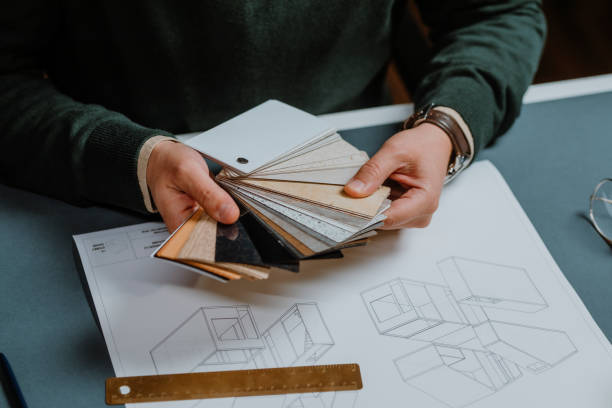 Anonymous Interior Designer Sitting in his Office and Making a Selection from a Sample Palette (Close Up)