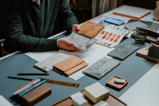 istock Hands of an Architect Working at His Studio: Choosing Stone Flooring Samples, a Close Up 1310504725