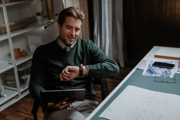 istock Businessman Sitting in his Office and Reading Something on his Digital Tablet 1310504751
