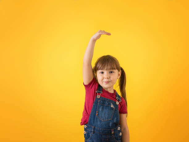 istock Girl checking how tall she's grown 1310506159