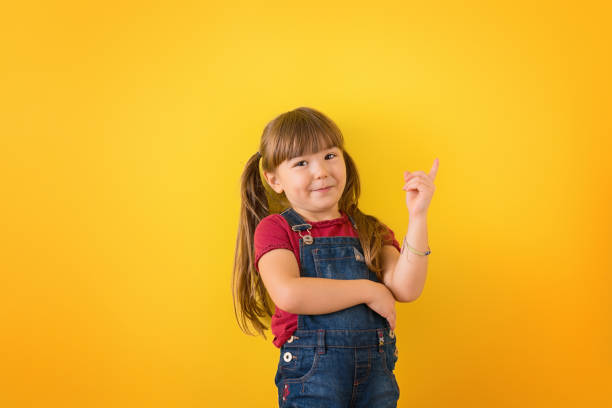 istock Funny child girl on colored background 1310506160