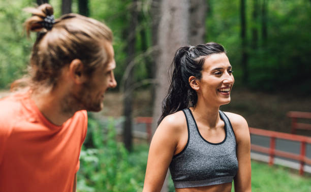 istock Happy Couple Talking and Laughing while Exercising in the forest 1310506206