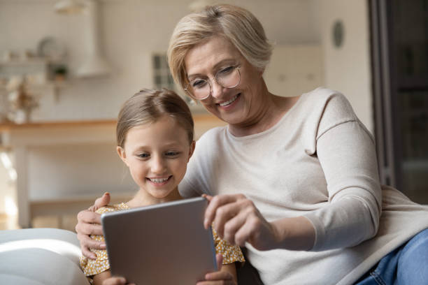 istock Smiling granny and small granddaughter use tablet 1310511800