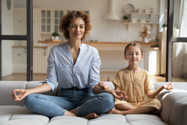 istock Calm young mom and small daughter practice yoga 1310511808