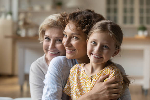 istock Happy three generations of women hug cuddle 1310511820