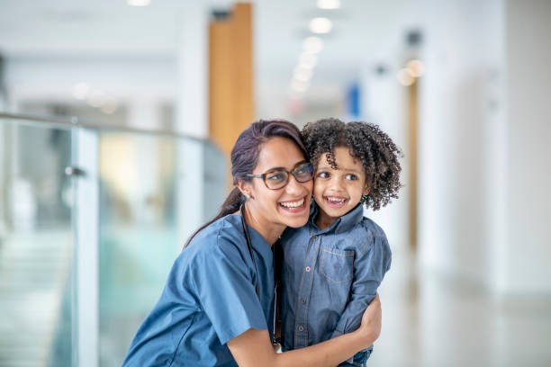 istock Female Doctor Hugging A Child Patient 1310511880