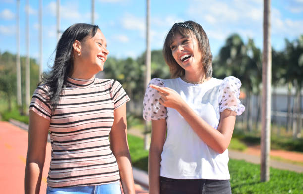 istock Two young friends taking a walk at a public park 1310514686