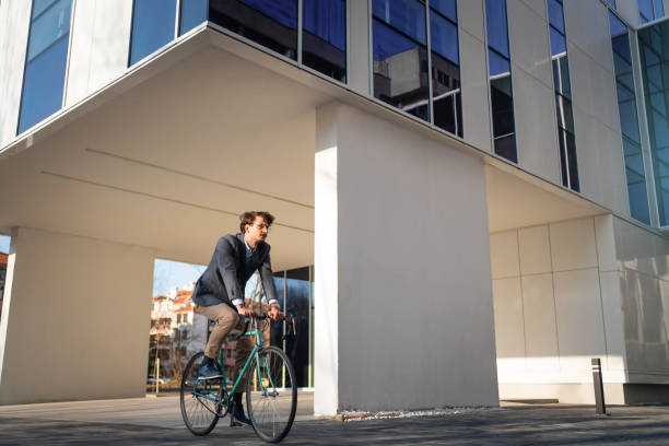 istock Young businessman coming to work on a bicycle 1310516171