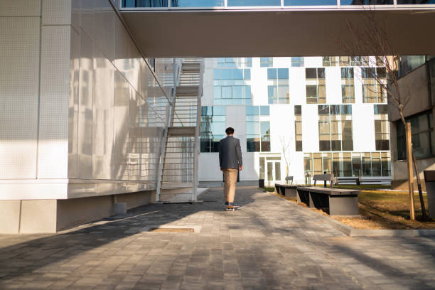 istock Back view of a young businessman on a skateboard 1310516187