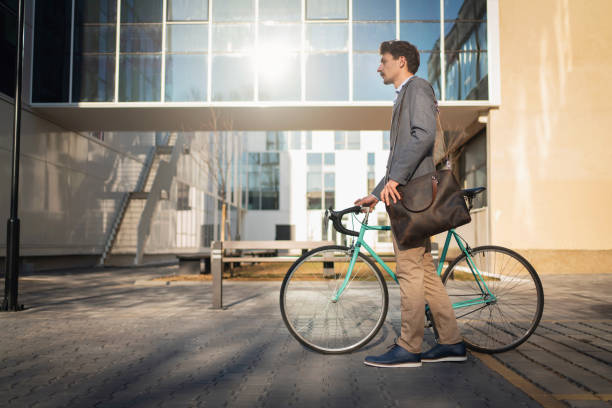 istock Young businessman walking with a bicycle,  commuting to work 1310516238