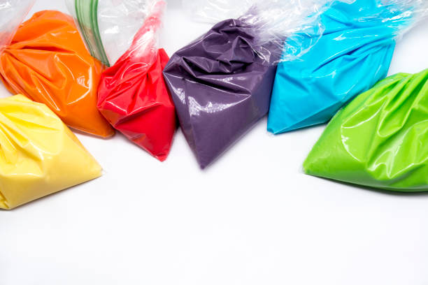 istock Piping bags with multicolored icing for cake or cookie decoration. Isolated on white background 1310516376