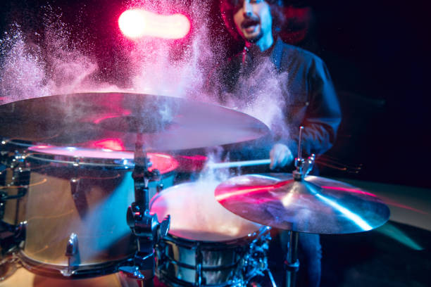 istock Drummer's rehearsing on drums before rock concert. Man recording music on drumset in studio 1310517475