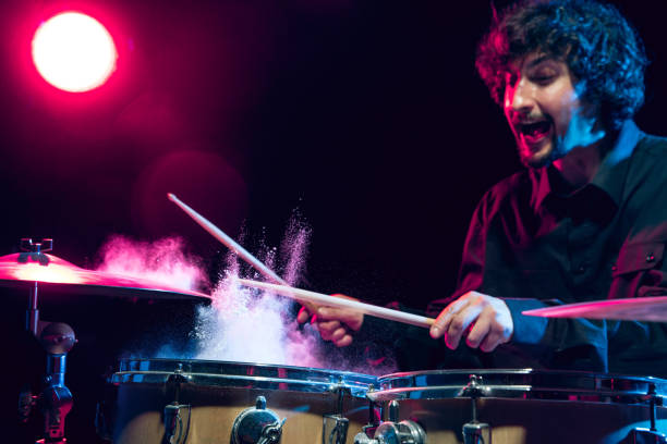 istock Drummer's rehearsing on drums before rock concert. Man recording music on drumset in studio 1310517480