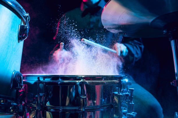 istock Drummer's rehearsing on drums before rock concert. Man recording music on drumset in studio 1310517498