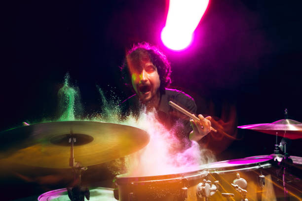 istock Drummer's rehearsing on drums before rock concert. Man recording music on drumset in studio 1310517507