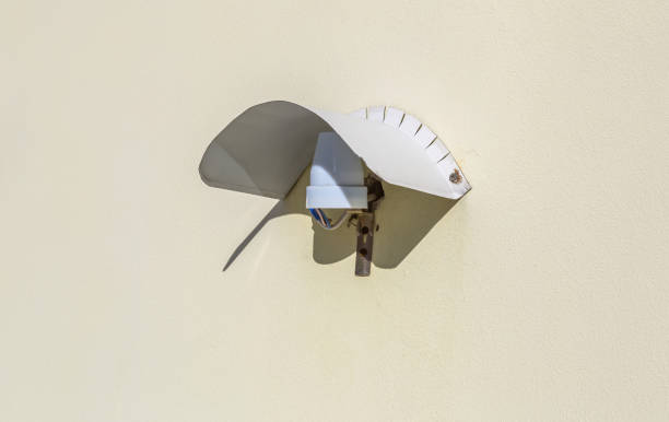 istock Street lamp without a bulb on a light stone wall 1310518163