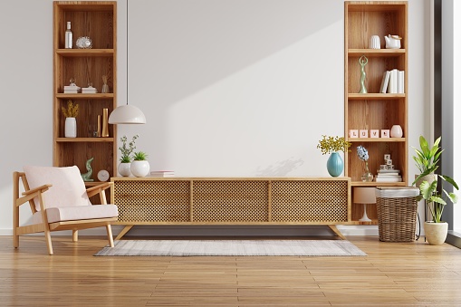 Armario para TV en la pared blanca en salón con sillón, diseño minimalista. photo
