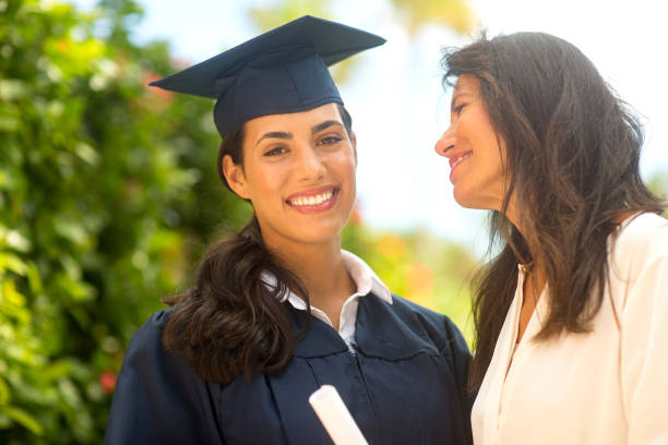 istock Mother hugging her daughter at her graduation 1310523758