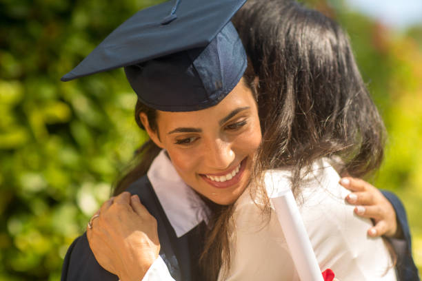 istock Mother hugging her daughter at her graduation 1310525473