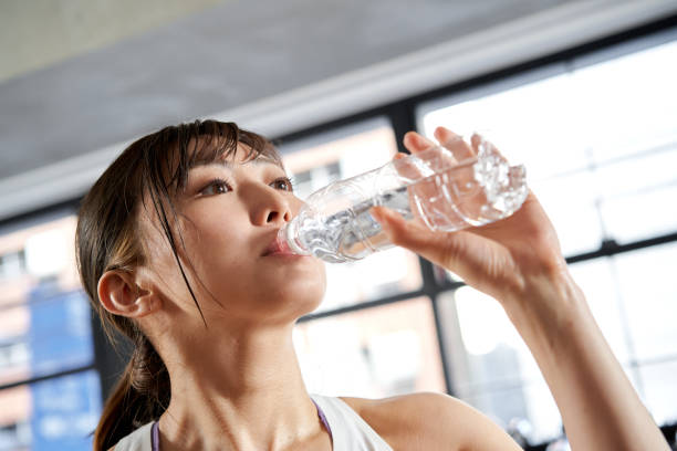 istock Asian women drinking water after training 1310528620