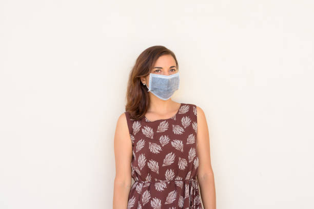 istock Woman wearing protective face mask against covid 19 virus while thinking 1310531763