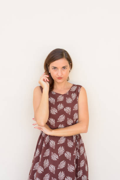 istock Serious beautiful woman outdoors againt plain wall vertical shot 1310531766