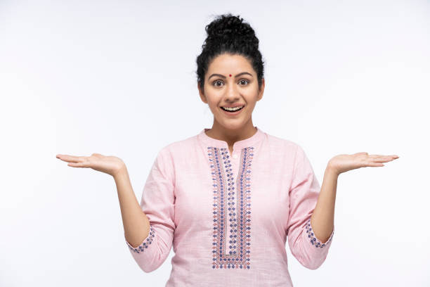 surprised women gesturing with arms having wide open eyes mouth isolated on blue background looking at camera:- stock photo - kurta imagens e fotografias de stock