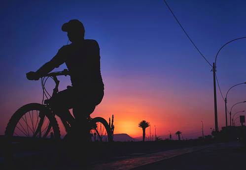 Silhouette bike on sunset and bicycle background. Cyclists against the sky at sunset. Selective focus