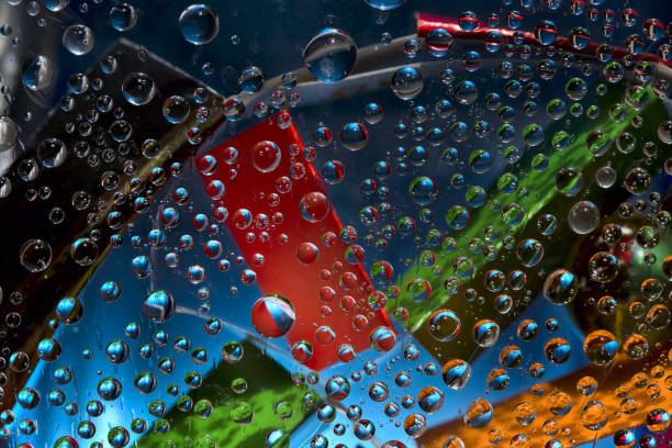 istock Transparent spheres are located against the blue background with multicolored geometric figures. 1310537165