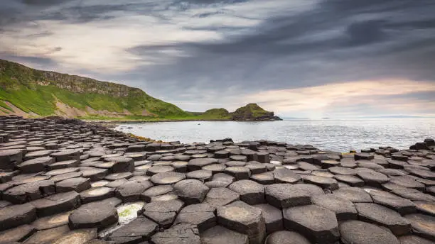 Giant's Causeway Scenic Landscape Sunset Panorama under moody twilight skyscpe. Ultrawideangle 10mm Panorama Landscape Shot. Giants Causeway, Antrim County, Northern Ireland, United Kingdom, Northern Europe, Europe