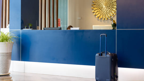 Unrecognizable porter bringing luggage into the hotel, copy space