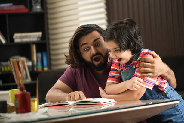 istock Father reading a book to his daughter 1310543693