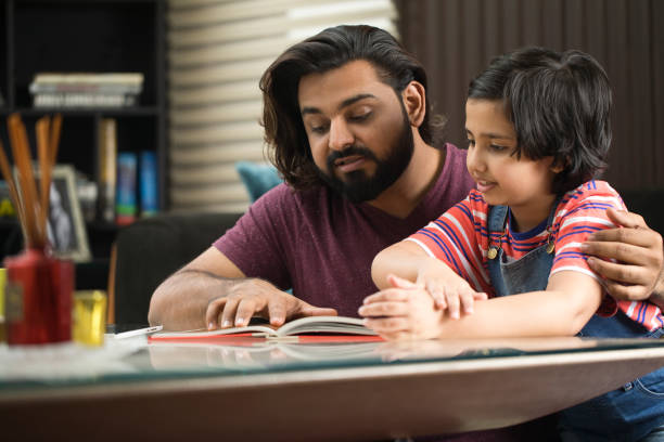 istock Father reading a book to his daughter 1310544293