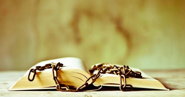 the chain on the book the closure of culture bible in chains stock pictures, royalty-free photos & images