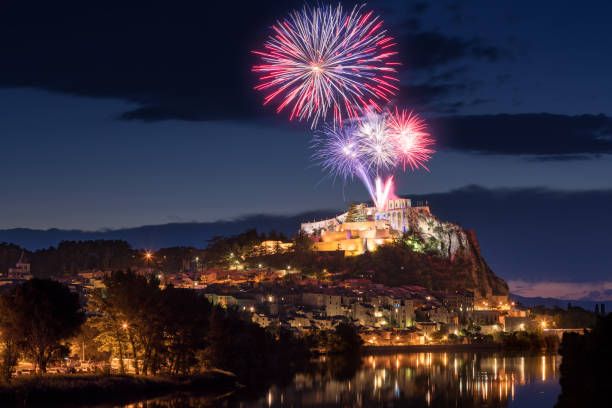 Sisteron with 14th of July fireworks (Bastille Day celebration) over the Citadel at twilight. Provence, Alpes-de-Haute-Provence, France The city of Sisteron with 14th of July fireworks (Bastille Day celebration) over the Citadel at twilight. Durance Valley, Alpes-de-Haute-Provence, France bastille day photos stock pictures, royalty-free photos & images