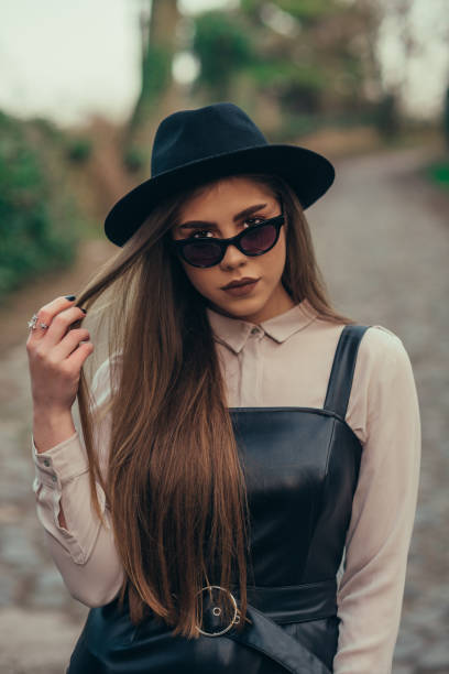 istock Woman posing with sunglasses and a hat 1310546798