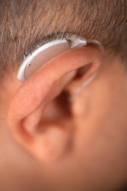 istock Modern digital hearing aid in ear of middle aged 40s 50s man 1310551178
